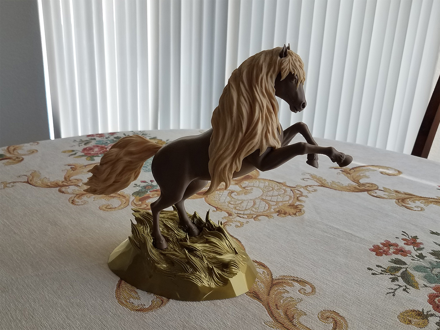 3D printed horse sculpture in multi-tone finish placed on a table, showing material contrast and physical realization of the digital model