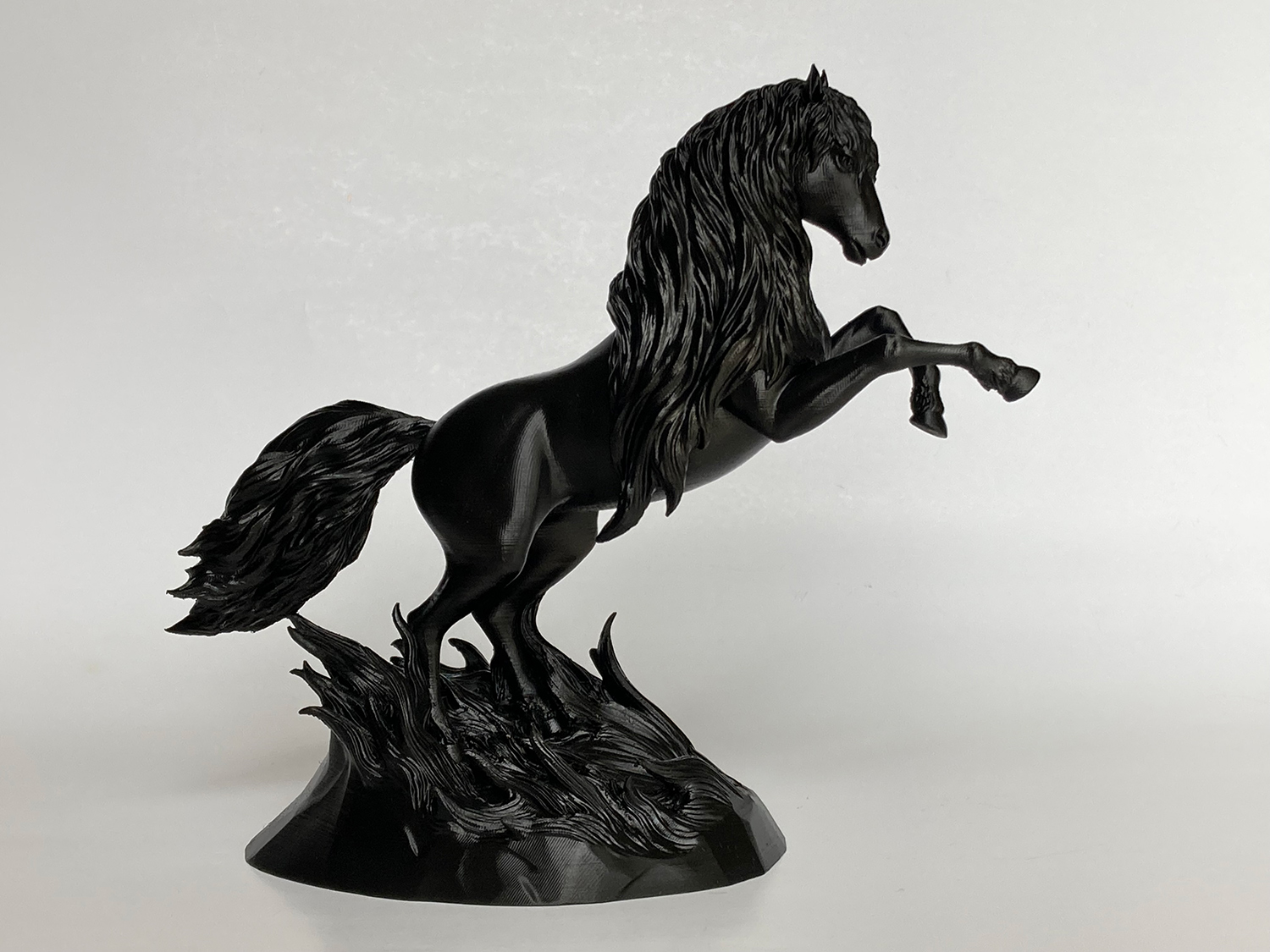 Black 3D printed horse sculpture in a polished dark finish, emphasizing silhouette, contrast, and sculptural presence