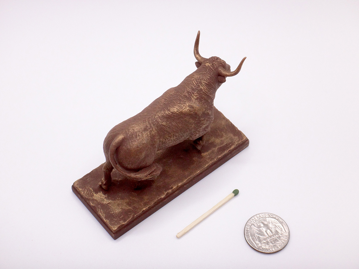 Bronze-toned bull sculpture viewed from behind showing surface texture and form