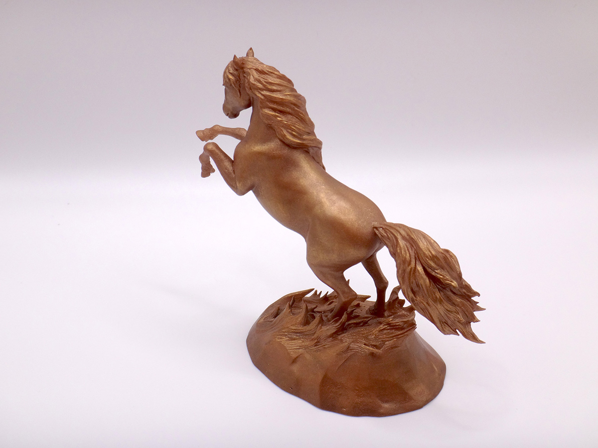 Bronze-toned horse sculpture viewed from the side showing movement and structure