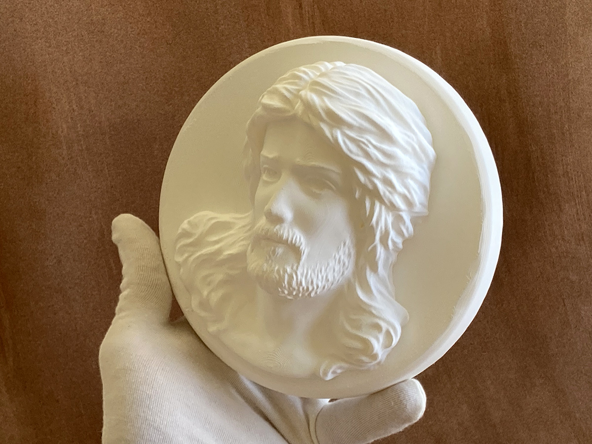 3D printed Jesus Christ bas-relief held in hand showing scale and detail