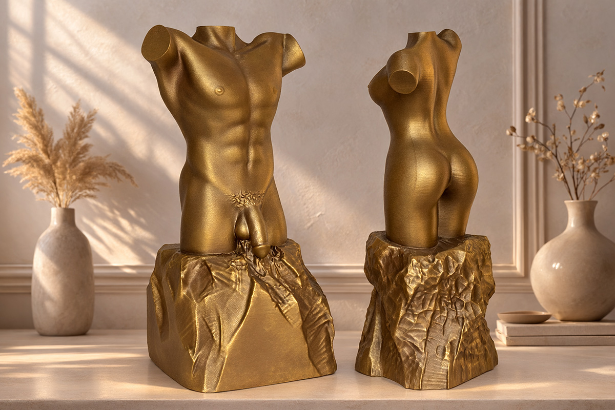 Male and female torso sculptures in warm bronze tones placed in a bright interior with soft natural light and decorative elements