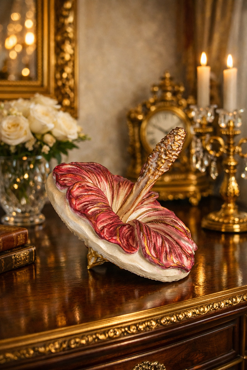 Red and gold mallow sculpture in an elegant interior with candles and ornate decor — rich and expressive art piece