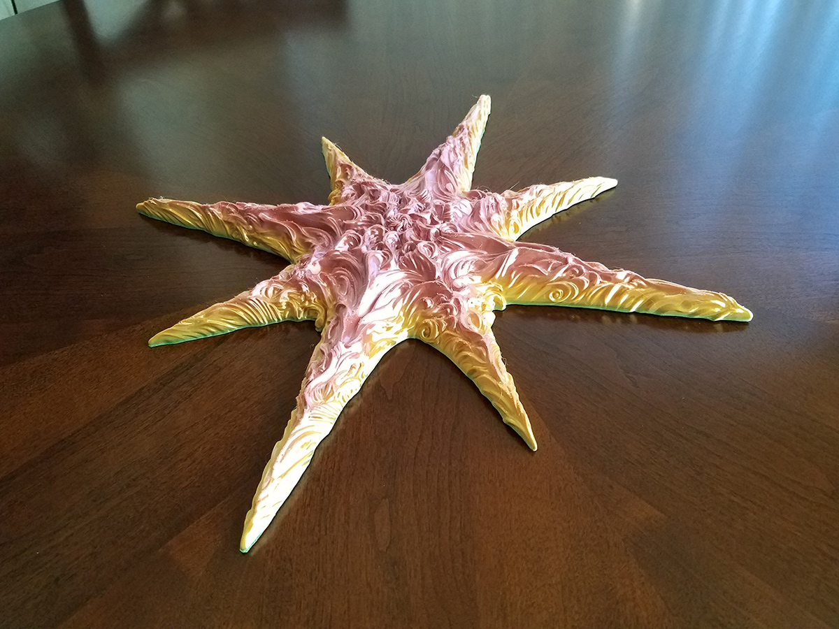 3d printed sculptural star object on wooden table showing scale and material presence