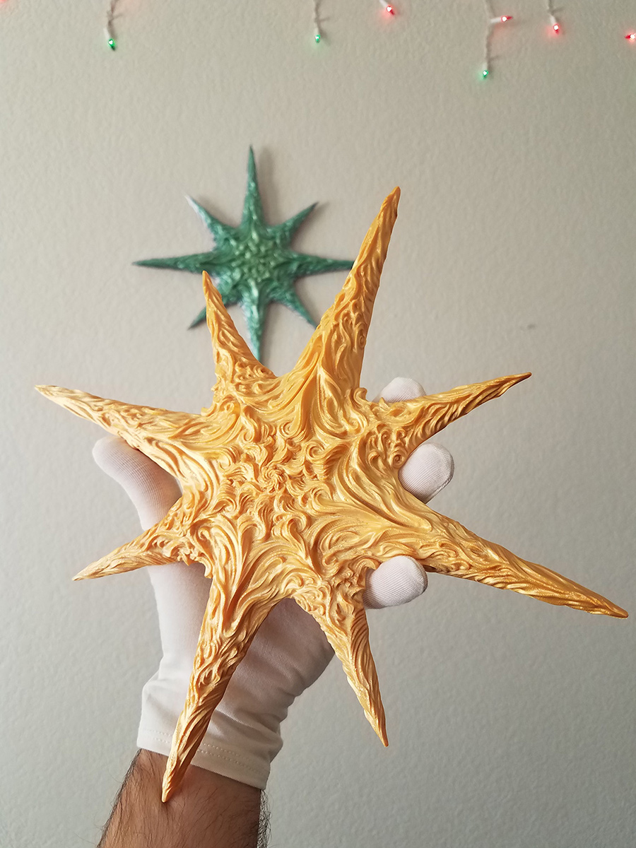 hand holding sculptural star object demonstrating size and potential for jewelry scale adaptation