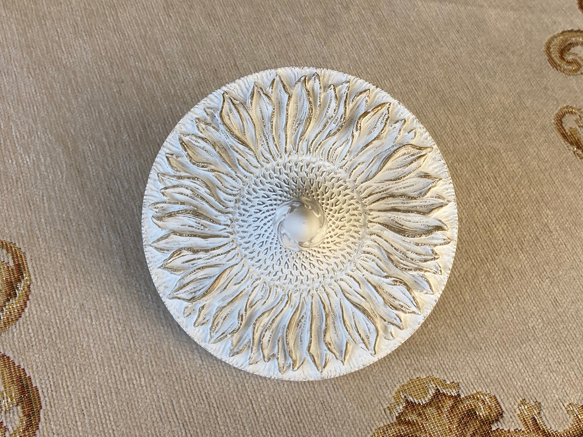 Sunflower bas-relief sculpture top view — detailed radial composition in white sculptural object