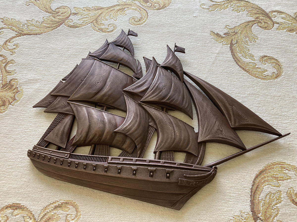 Decorative sailing ship bas-relief sculpture with antique finish, presented as a wall-mounted interior object